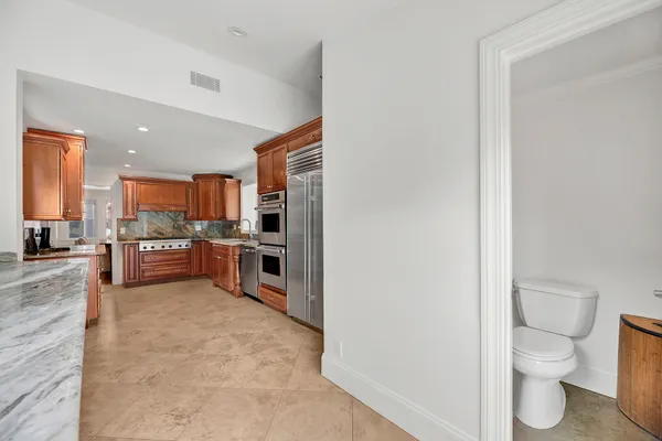 a large open kitchen with a sink and a stove top oven