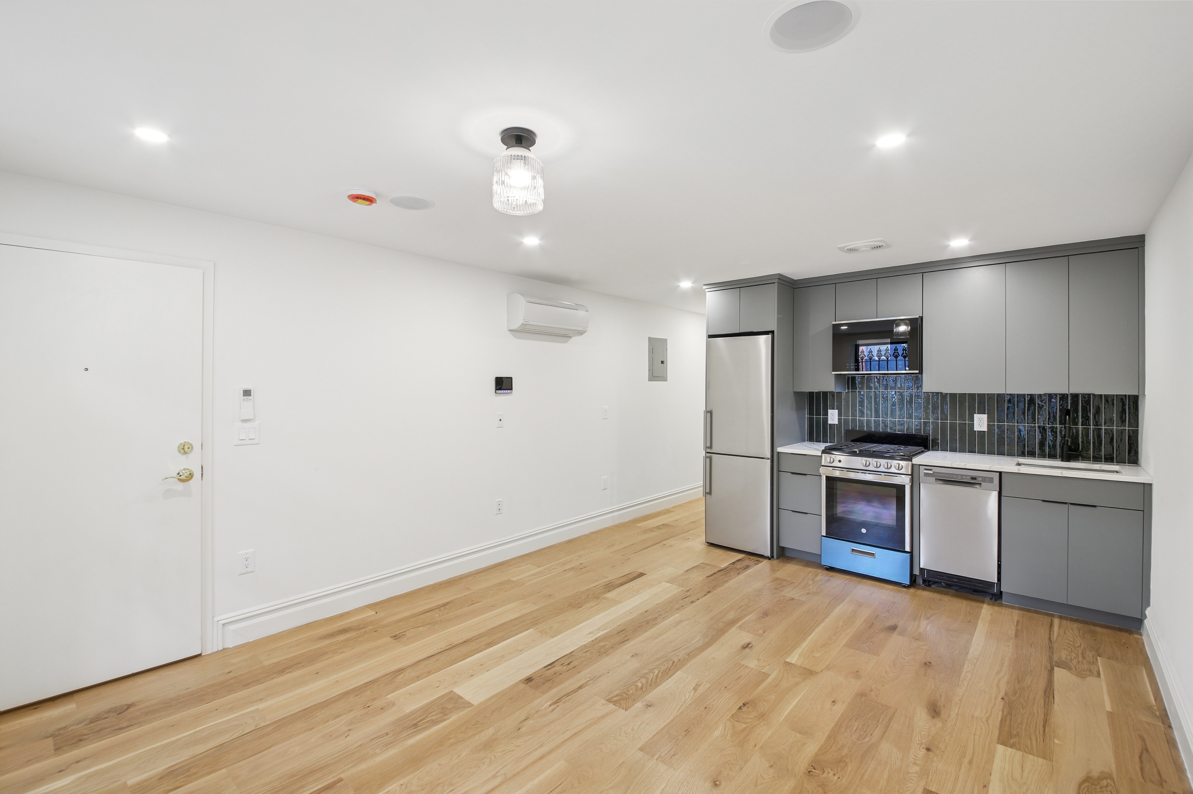 239 Madison Street, Unit 1 Brooklyn, NY 11216 - Photo 13 of 14 a kitchen with stainless steel appliances a refrigerator and a stove top oven