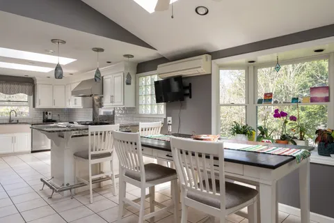 a view of a dining room with furniture window and outside view