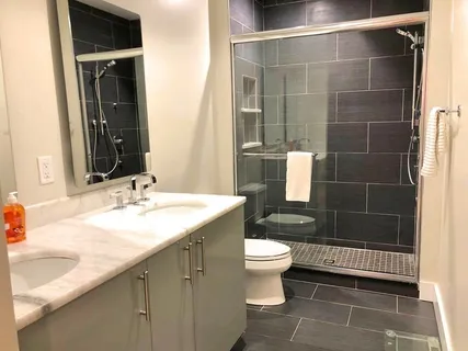 a bathroom with a sink toilet a mirror and shower
