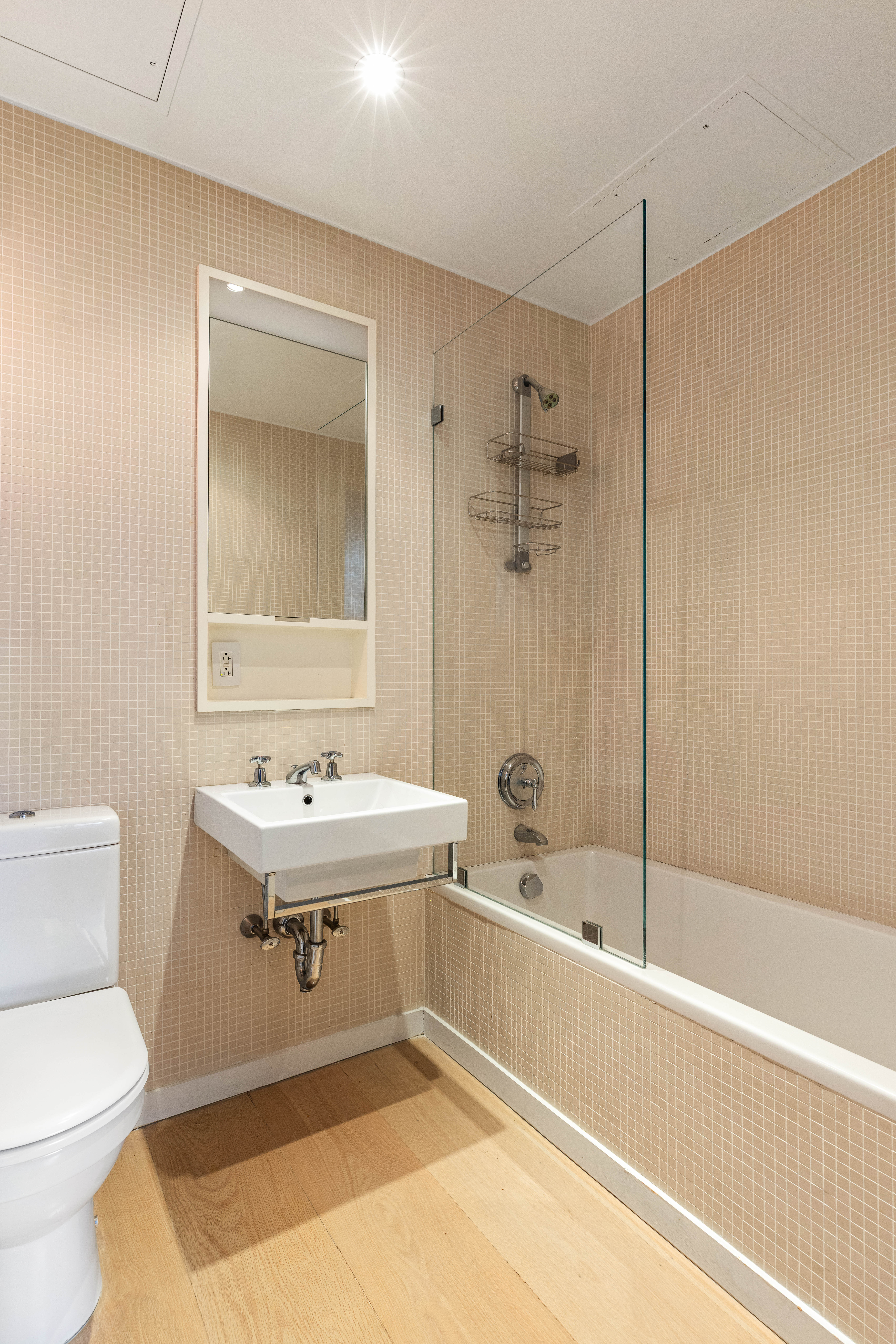 456 West 19th Street, Unit 2/3F Manhattan, NY 10011 - Photo 10 of 14 a bathroom with a sink mirror toilet and bathtub
