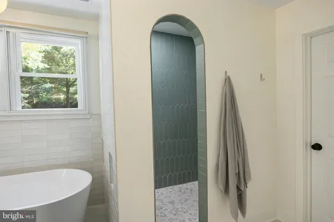 a bathroom with a tub and sink