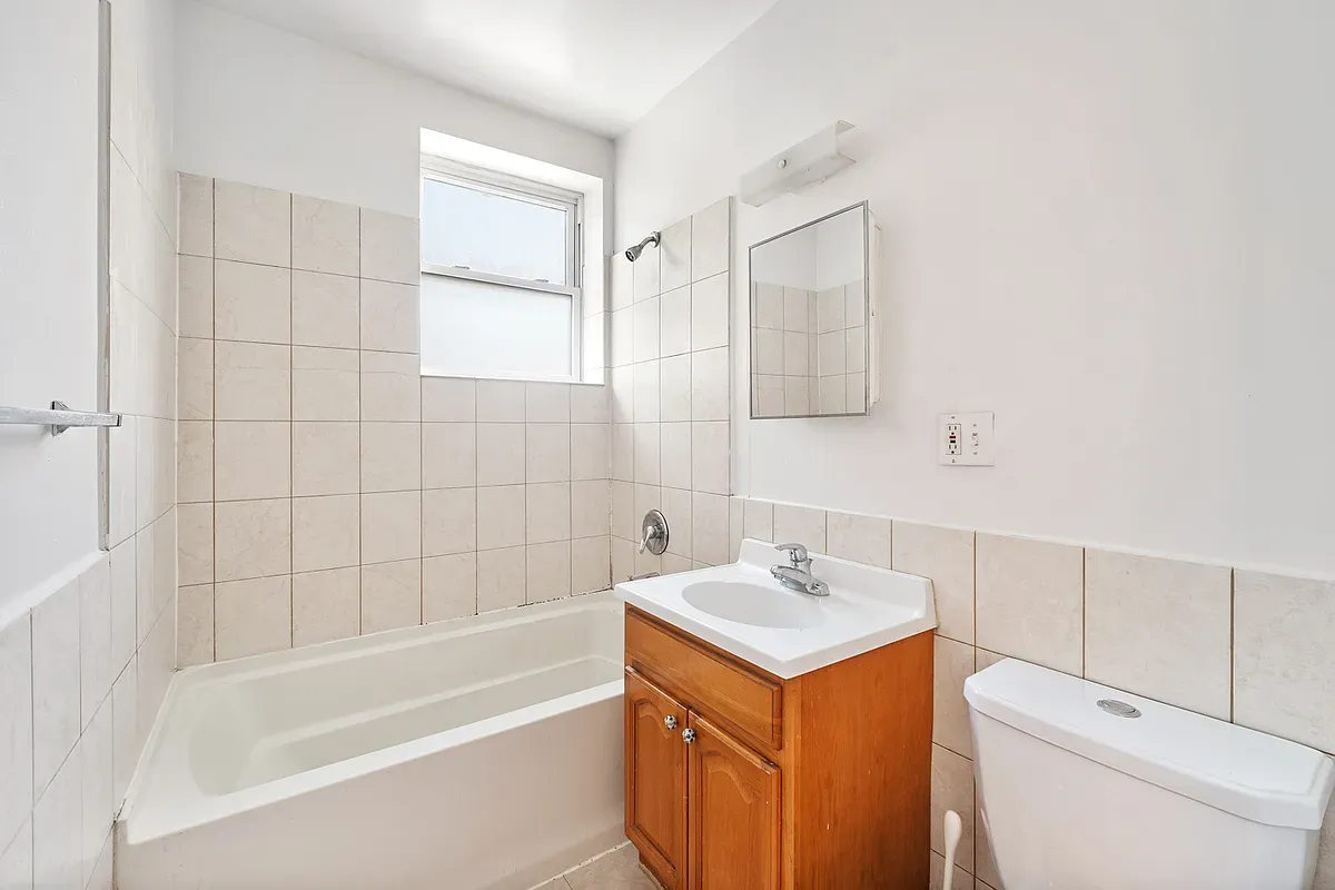 a bathroom with a sink toilet vanity and tub