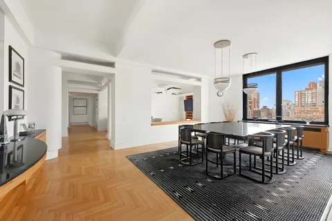 a kitchen with a checkered floor and white cabinets