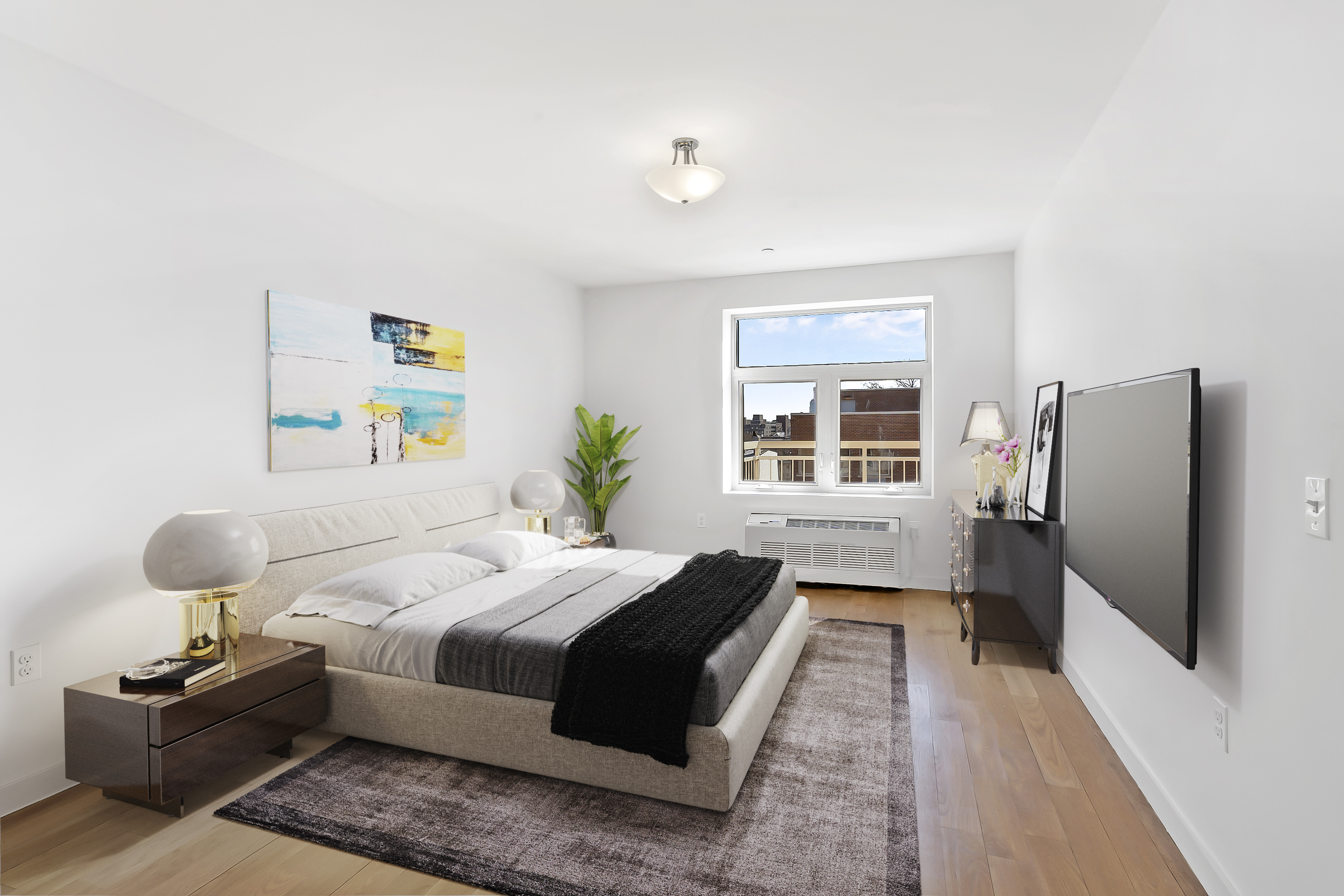 26-20 14th Place, Unit 3C Queens, NY 11102 - Photo 3 of 13 a bedroom with a bed flat screen tv on desk and a window