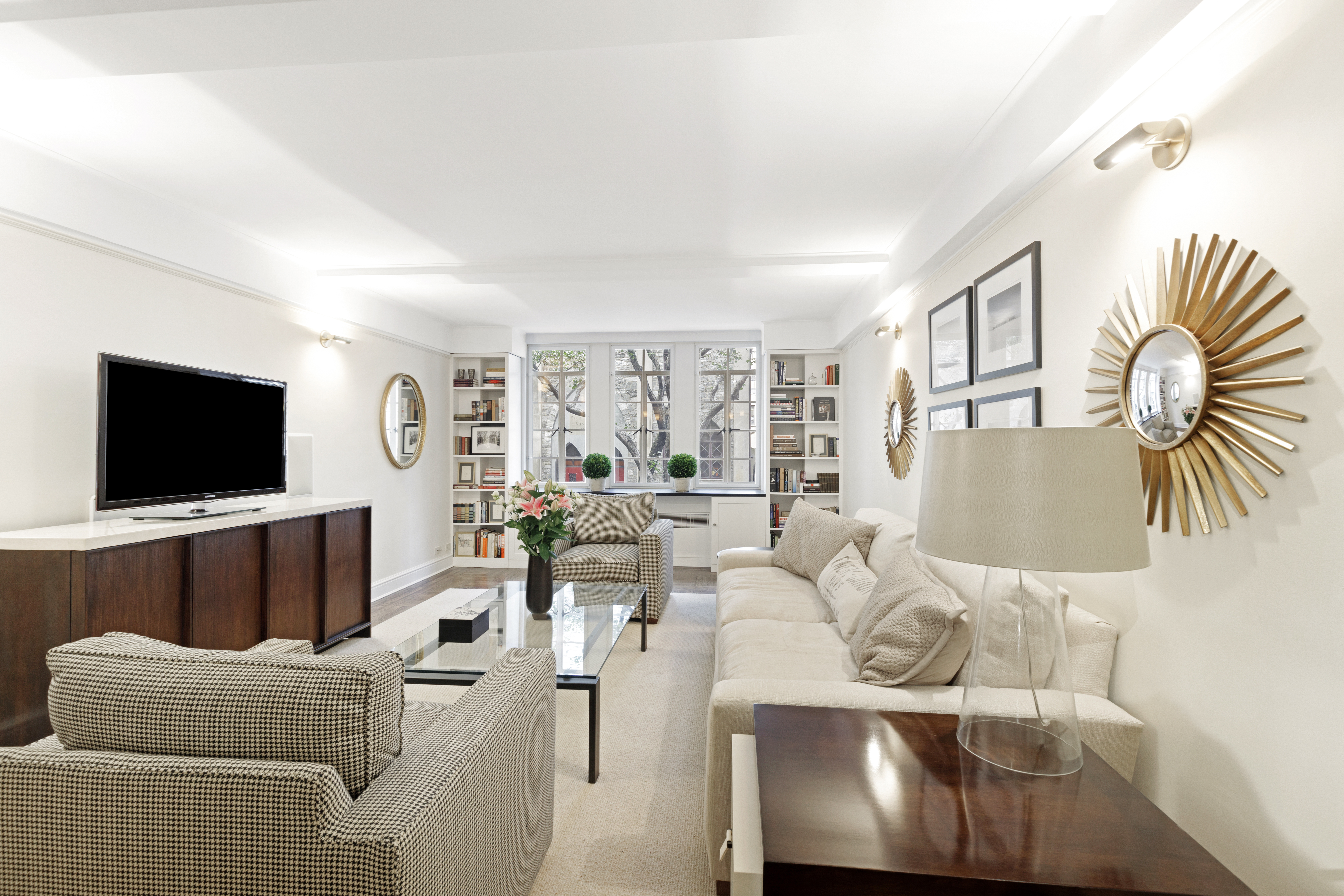 110 East 87th Street, Unit 2C Manhattan, NY 10128 - Photo 2 of 12 a living room with furniture and a flat screen tv