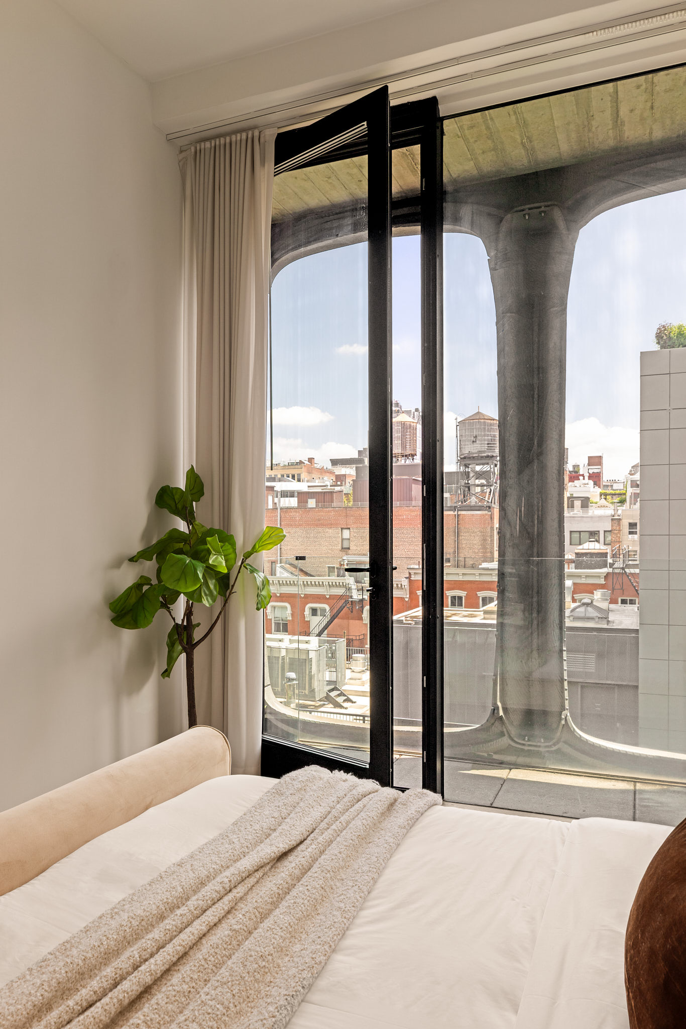 325 West Broadway, Unit 7B Manhattan, NY 10013 - Photo 13 of 21 a bedroom with a bed and a potted plant