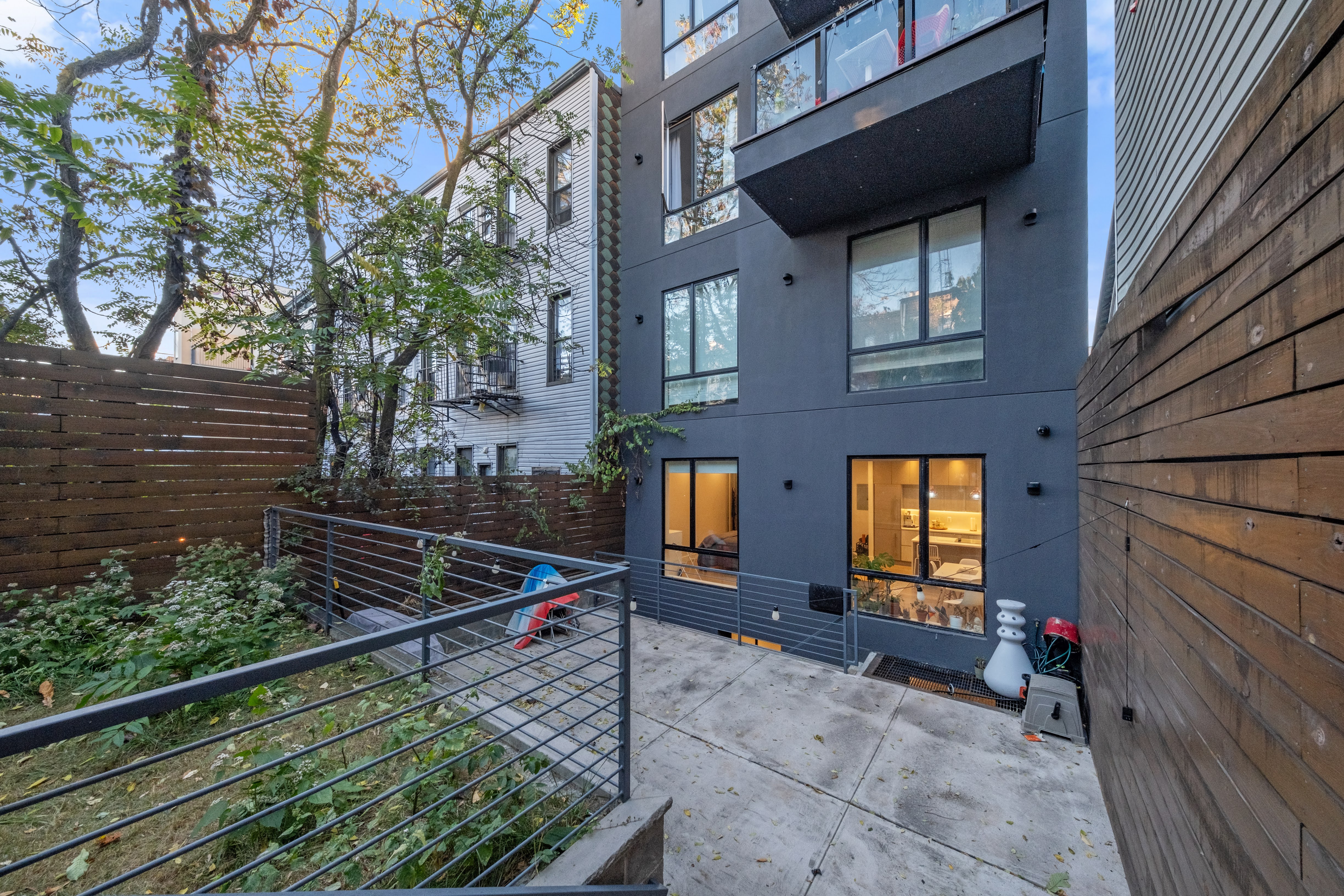 394 Harman Street, Unit 1B Brooklyn, NY 11237 - Photo 19 of 23 a view of a brick house with a small yard