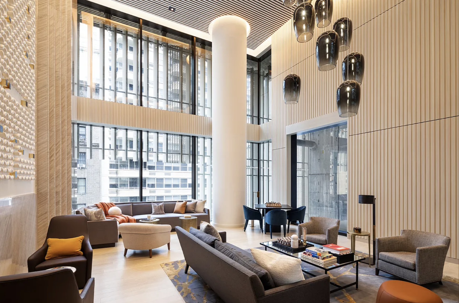138 East 50th Street, Unit 40B Manhattan, NY 10022 - Photo 20 of 22 a living room with furniture and large windows