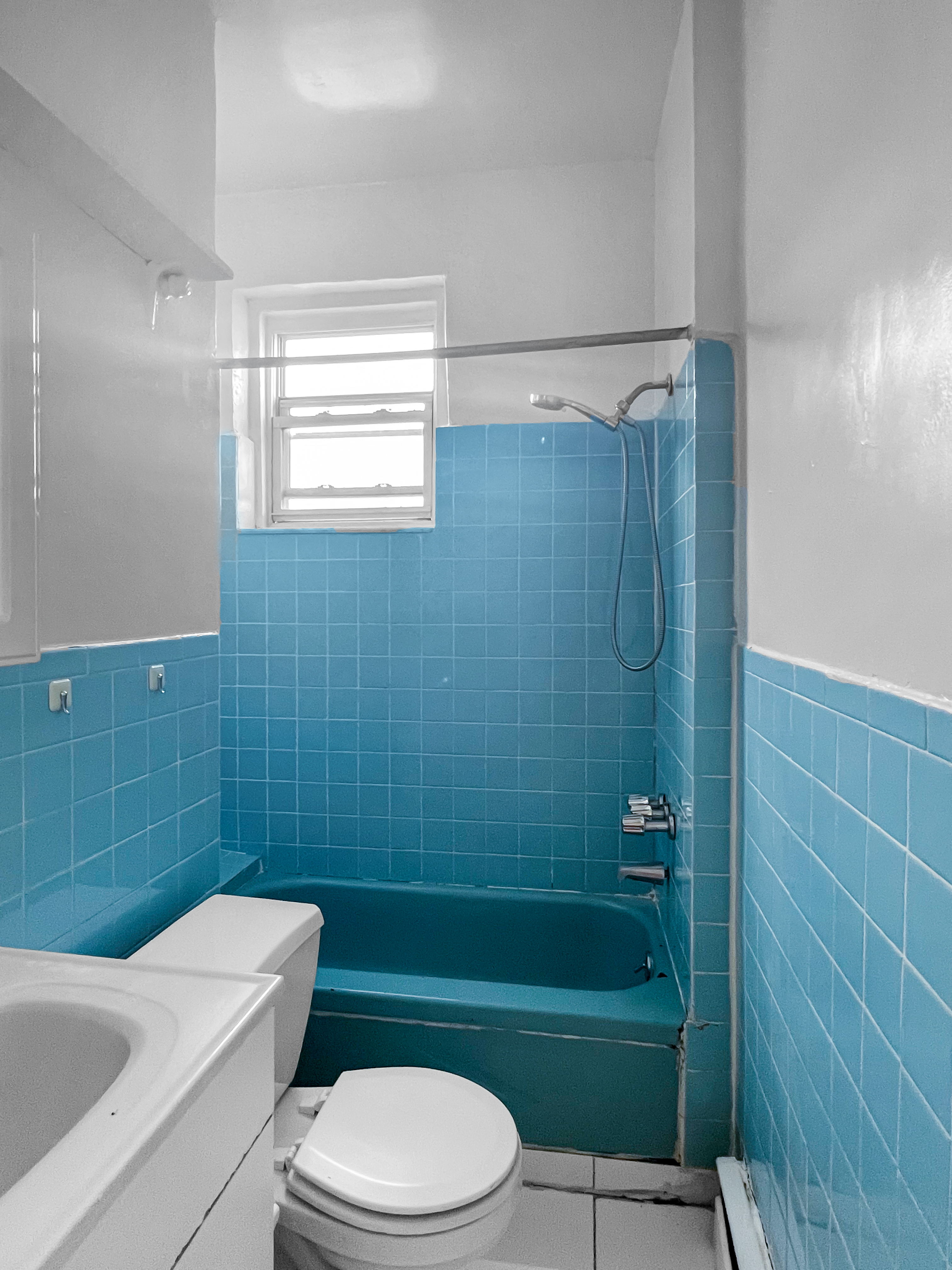 35-19 Broadway, Unit 3 Queens, NY 11106 - Photo 11 of 11 a bathroom with a sink a toilet a mirror a bathtub and shower