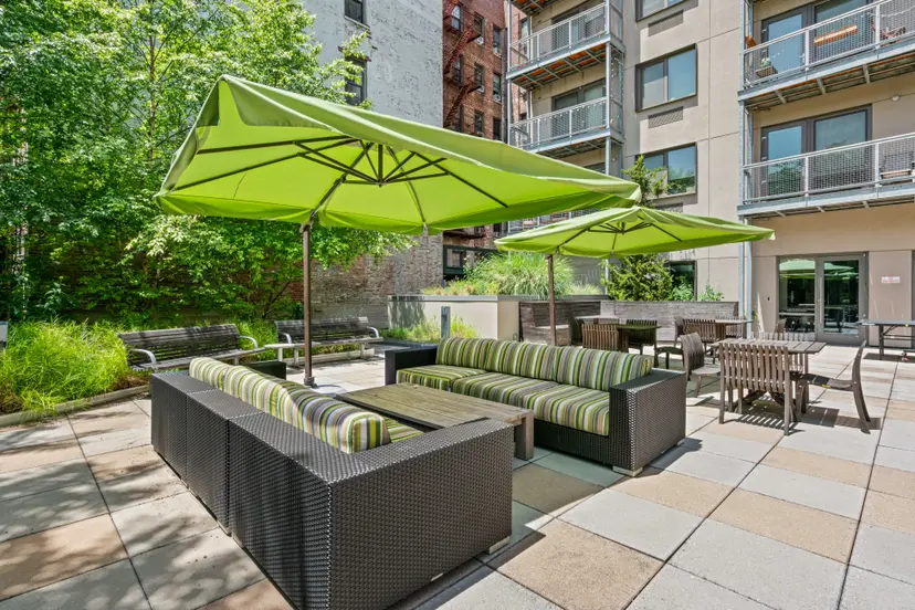 22 Caton Place, Unit 4H Brooklyn, NY 11218 - Photo 19 of 20 a view of a patio with a table and chairs under an umbrella