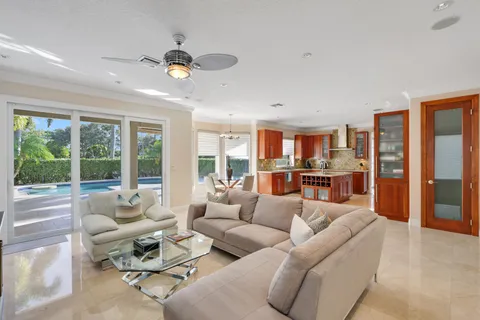 a living room with stainless steel appliances granite countertop furniture and a view of kitchen