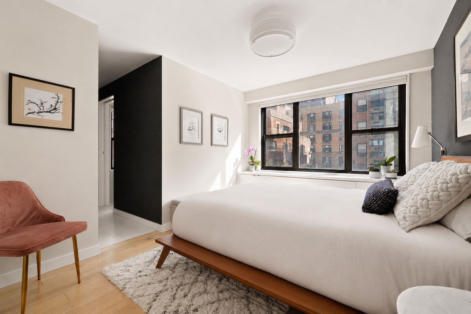 1065 Park Avenue, Unit 10CD Manhattan, NY 10128 - Photo 4 of 10 a bedroom with a bed and glass window