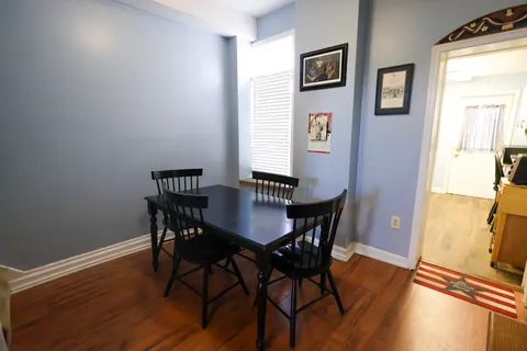 a view of a dining room with furniture and wooden floor