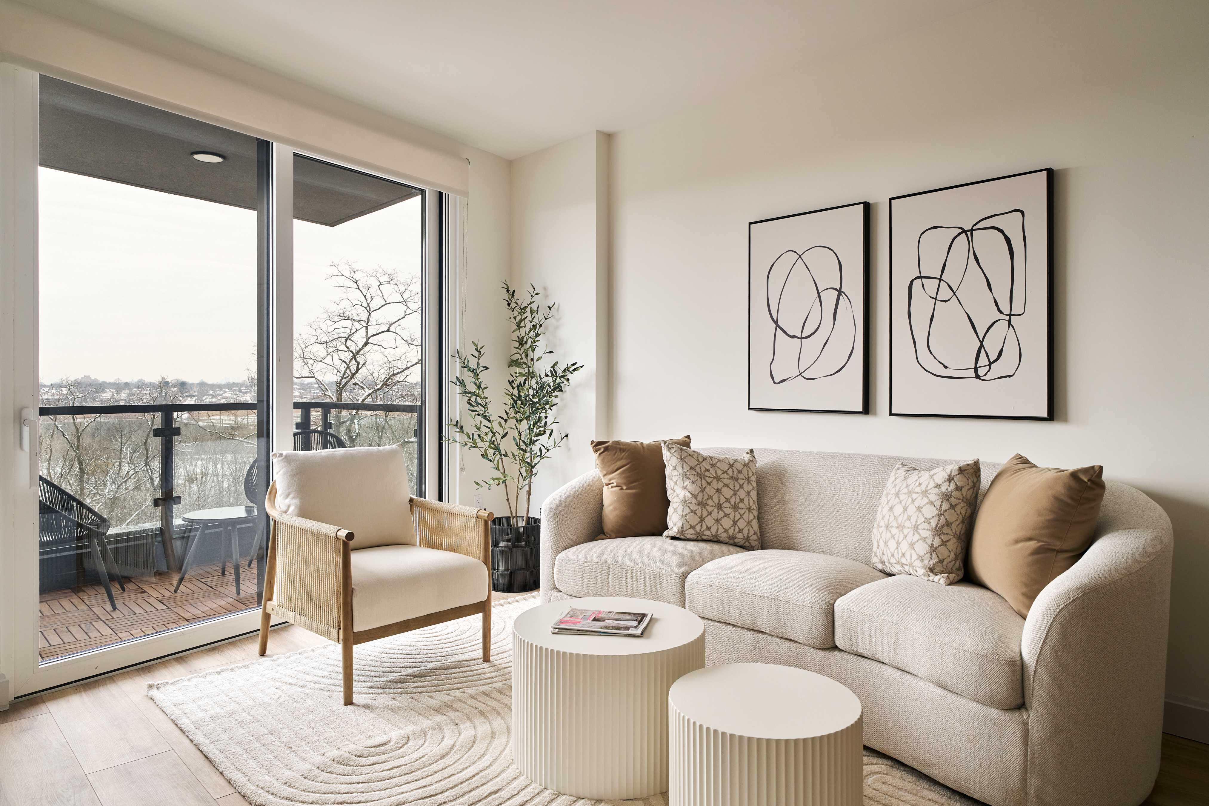 44-14 Douglaston Parkway, Unit 3B Queens, NY 11363 - Photo 3 of 12 a living room with furniture and a floor to ceiling window