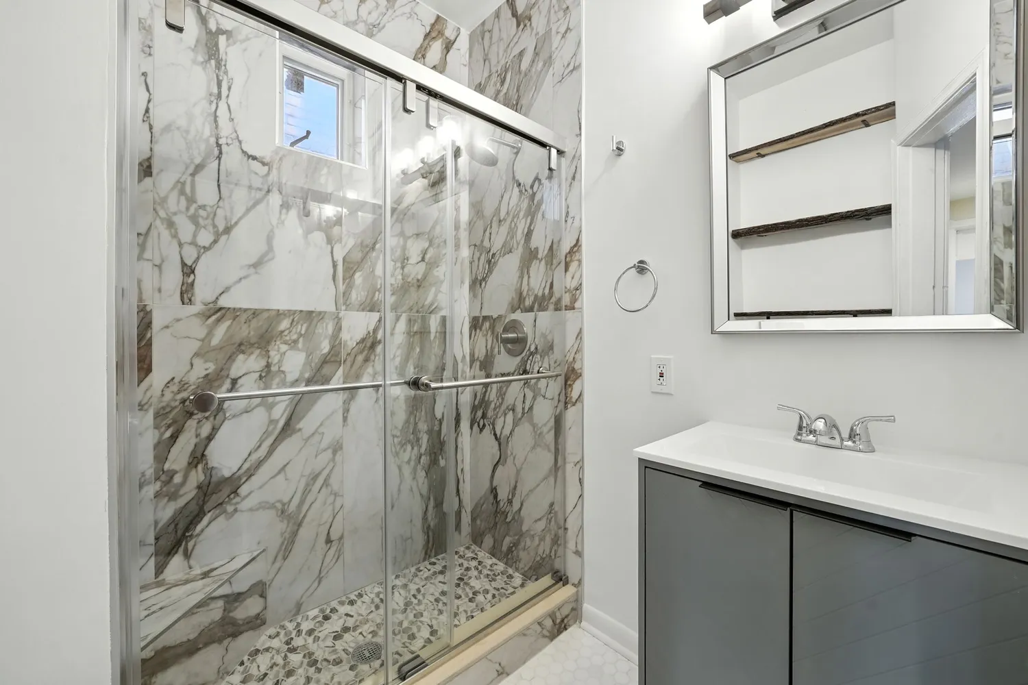 a bathroom with a shower and a sink