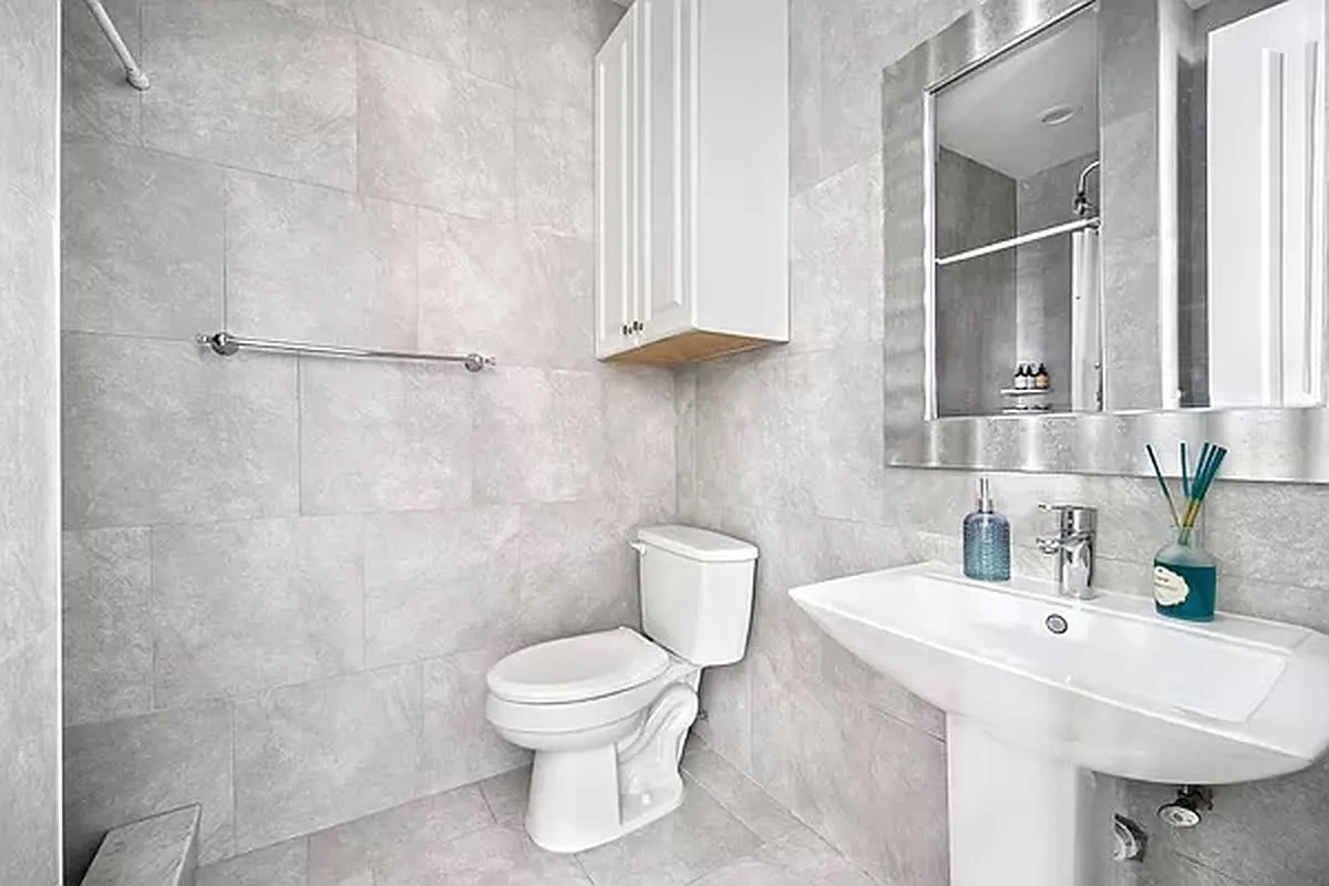 320 7th Avenue, Unit 1 Brooklyn, NY 11215 - Photo 6 of 7 a bathroom with a toilet sink and mirror