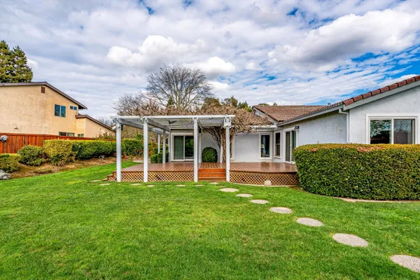 a view of a house with a yard and plants