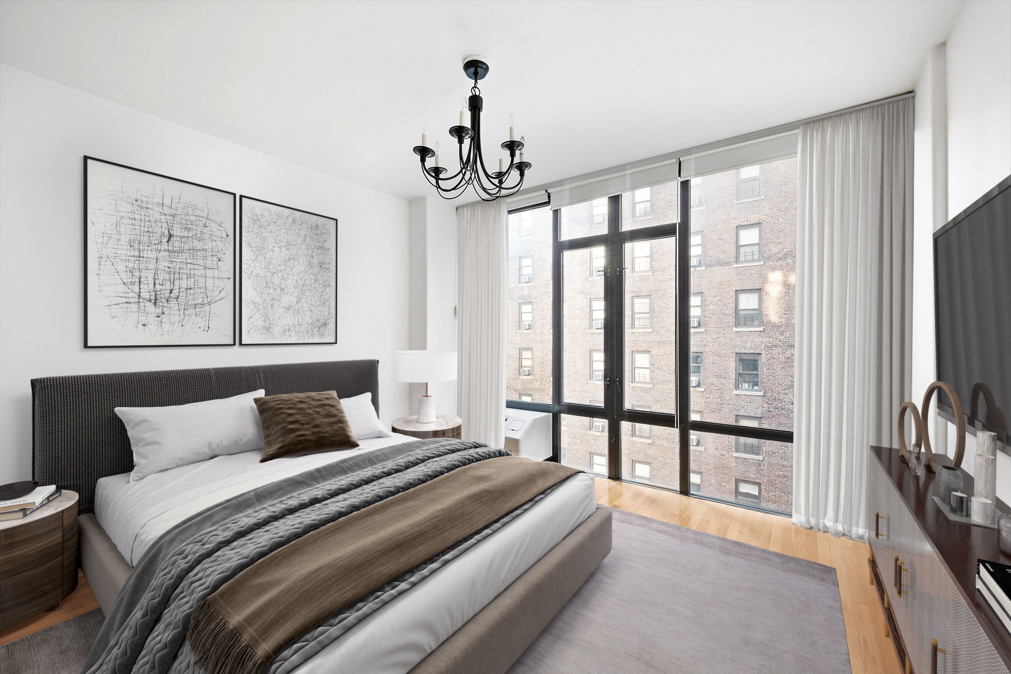 148 East 24th Street, Unit 6E Manhattan, NY 10010 - Photo 2 of 12 a bedroom with a large bed and a chandelier