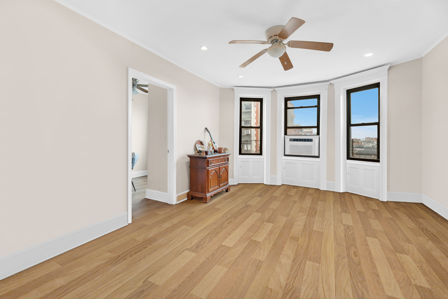 571 8th Street Brooklyn, NY 11215 - Photo 2 of 13 a view of empty room with wooden floor and fan