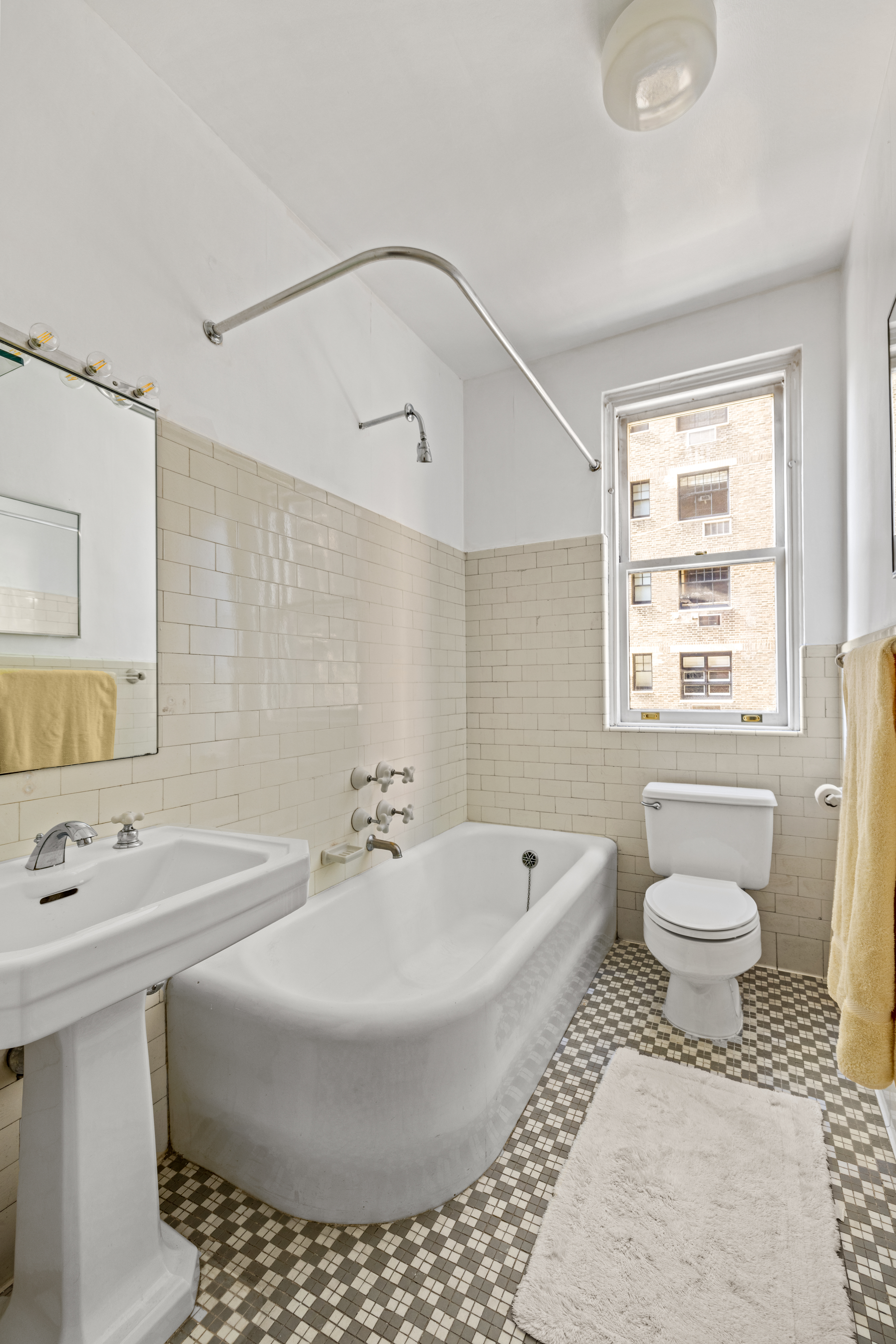75 Central Park West, Unit 5A Manhattan, NY 10023 - Photo 9 of 14 a bathroom with a bathtub and a sink