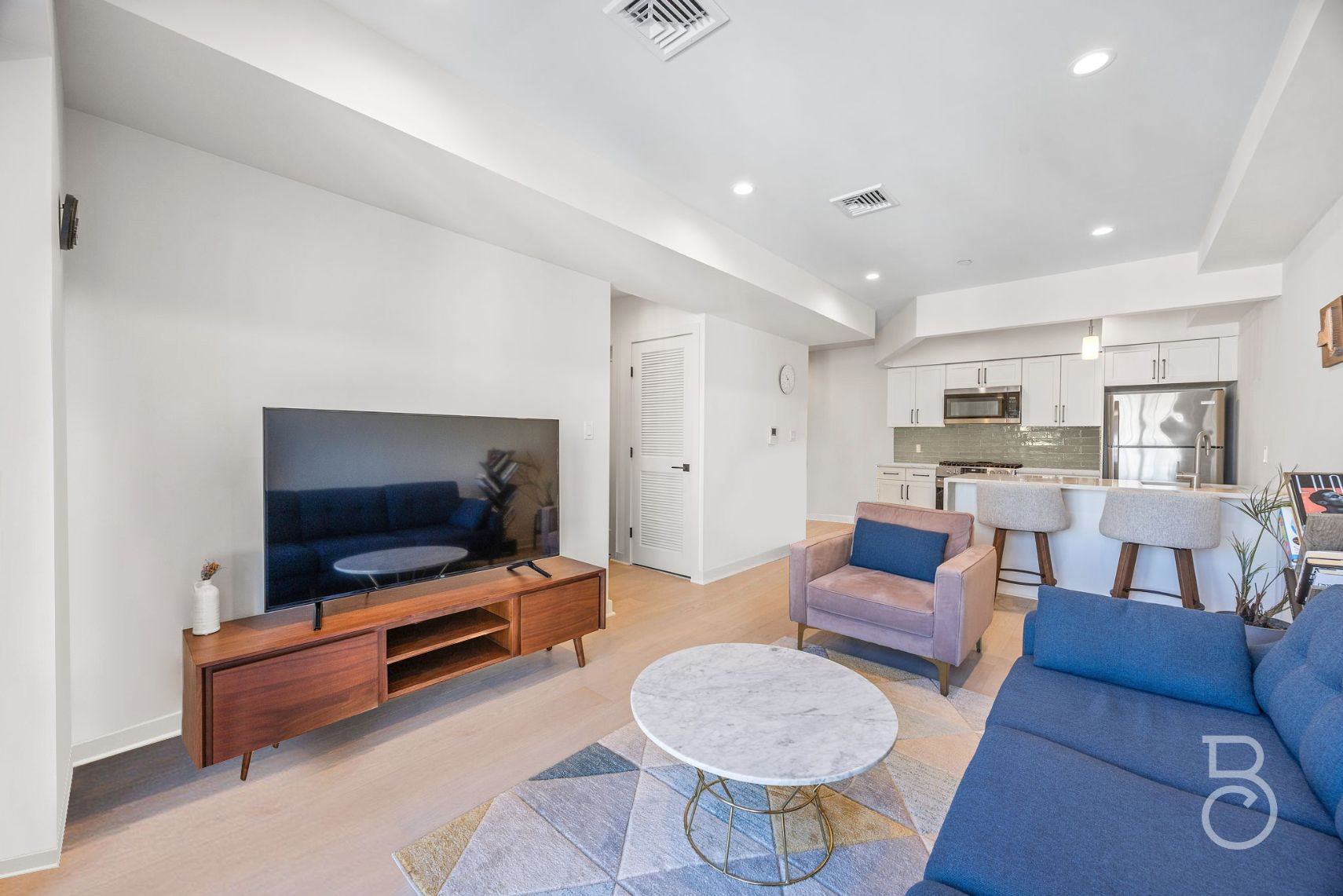 25-74 34th Street, Unit 4C Queens, NY 11103 - Photo 4 of 15 a living room with furniture and a flat screen tv