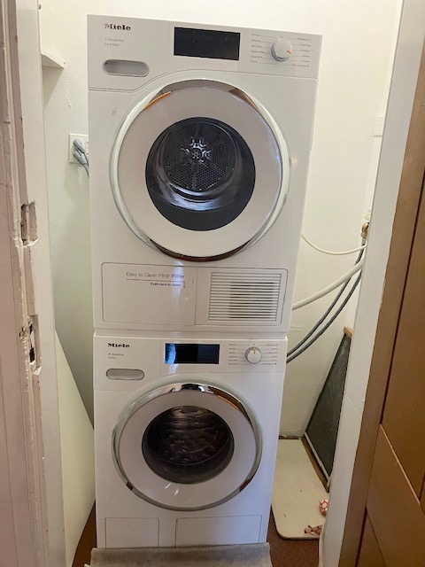 214 East 12th Street, Unit 4 Manhattan, NY 10003 - Photo 9 of 9 a utility room with dryer and washer