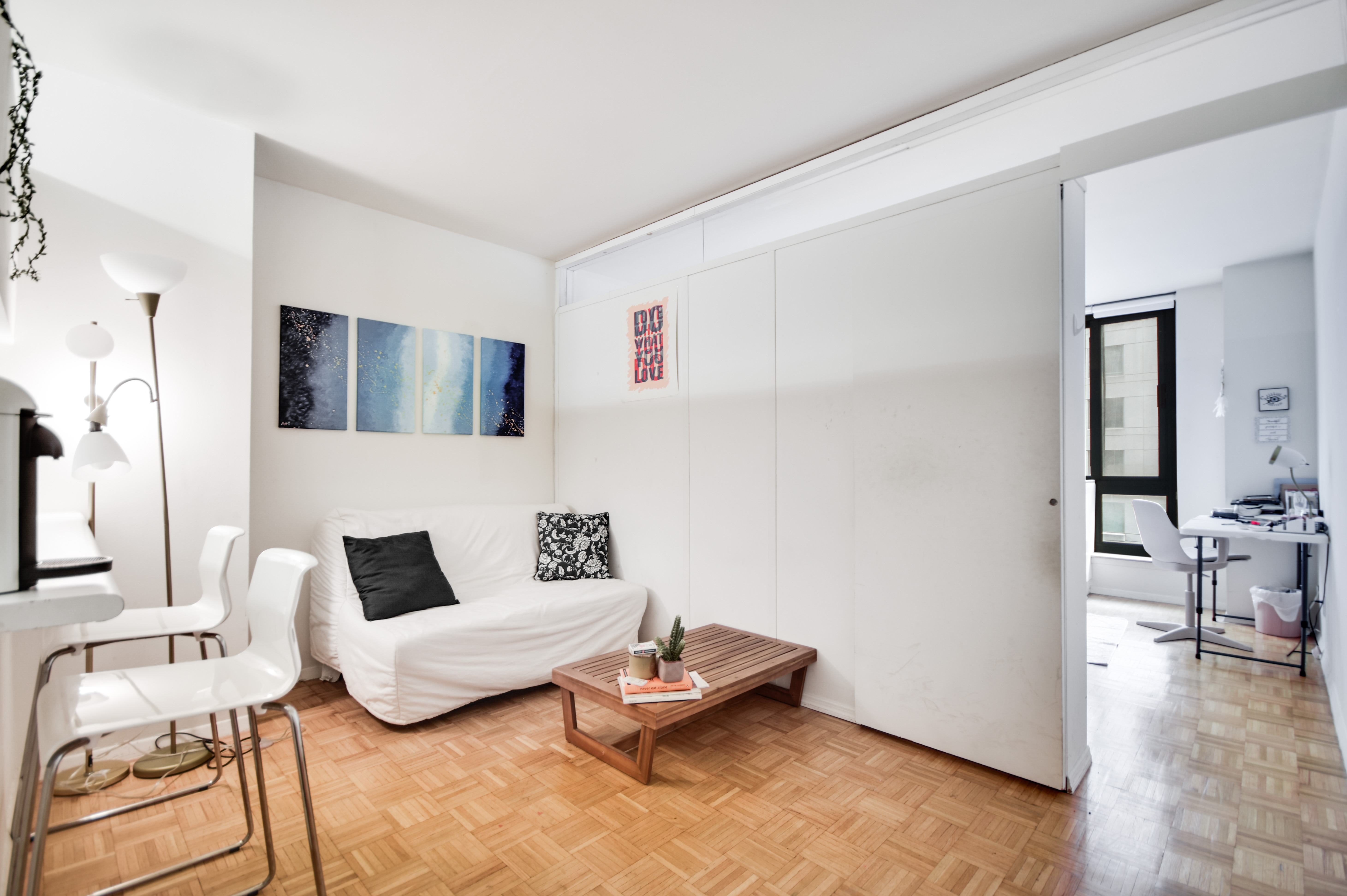 a living room with furniture and wooden floor