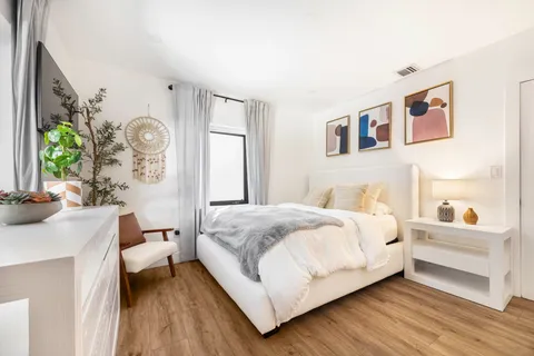 a bedroom with a large bed and a large window