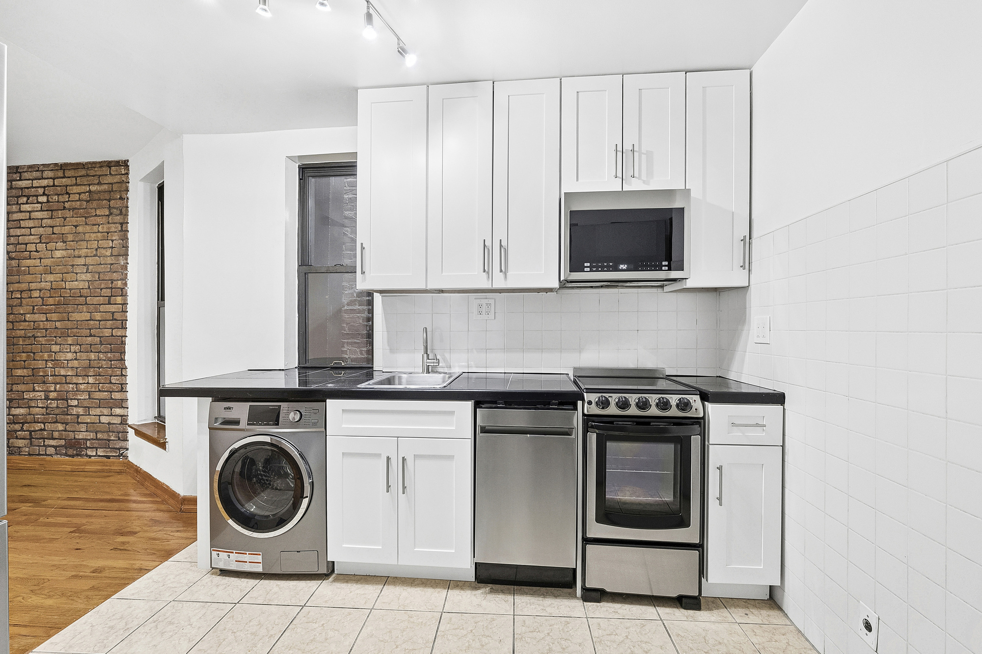 5 Cornelia Street, Unit 5B Manhattan, NY 10014 - Photo 3 of 7 a stove top oven sitting inside of a kitchen