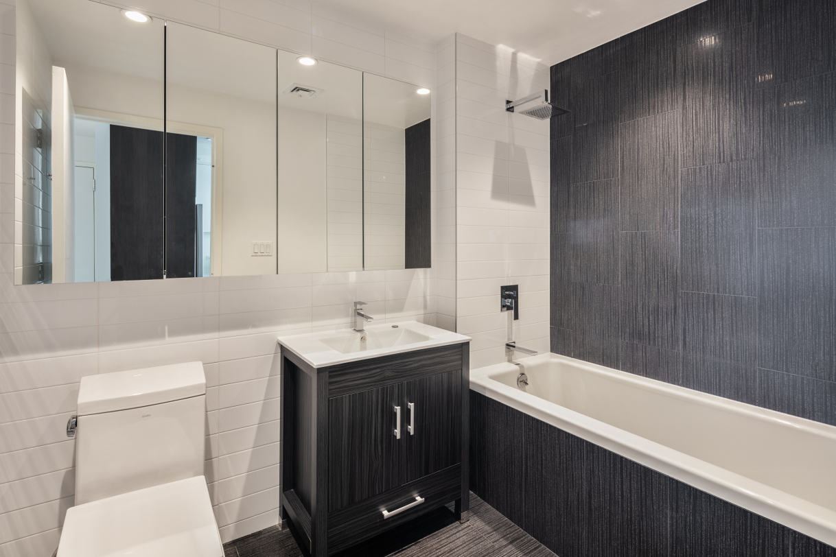 834 Sterling Place, Unit 203 Brooklyn, NY 11216 - Photo 6 of 12 a bathroom with a sink a toilet and shower