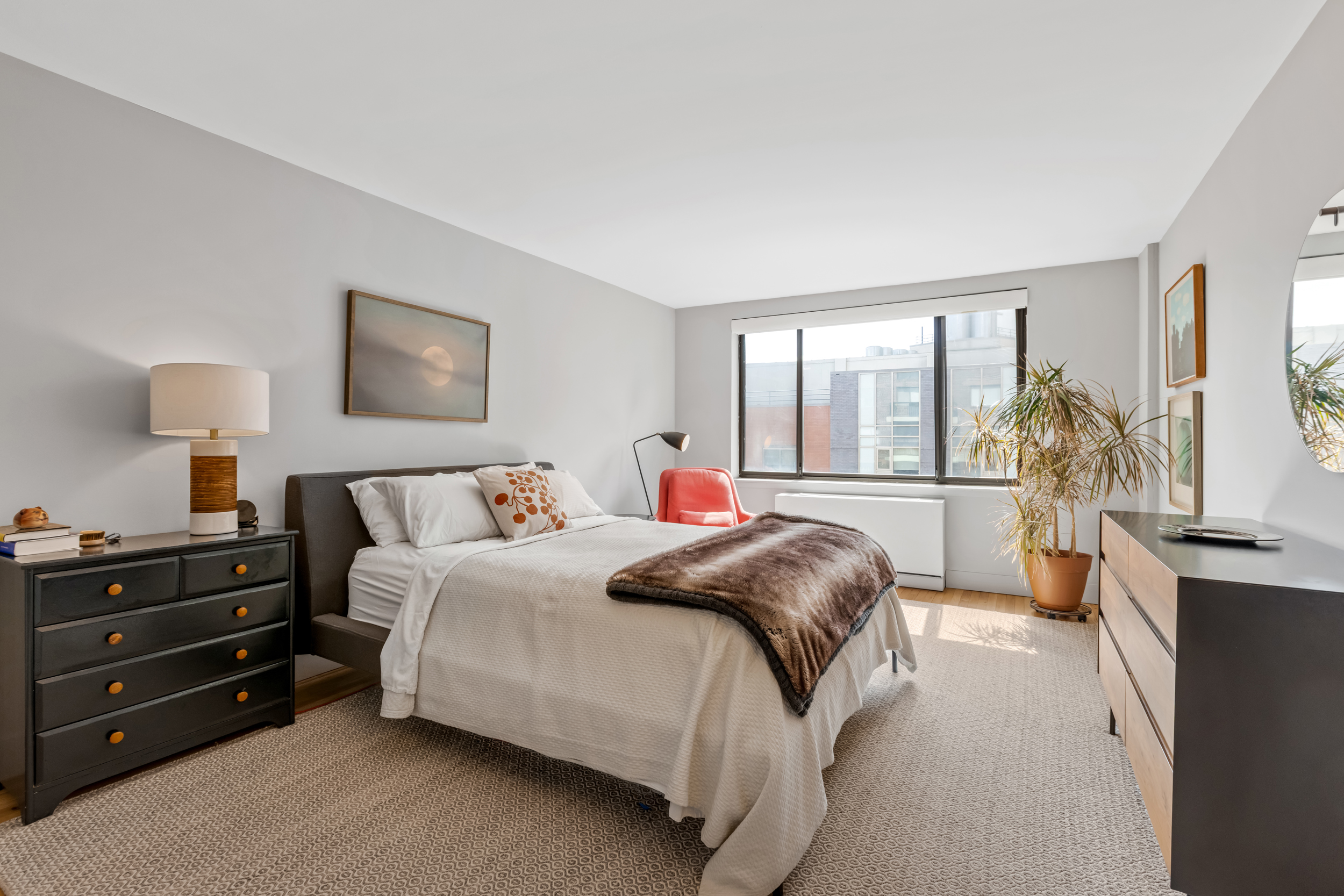 63 Downing Street, Unit 8C Manhattan, NY 10014 - Photo 8 of 15 a bedroom with a bed and a large window