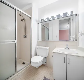 a bathroom with a toilet sink and shower