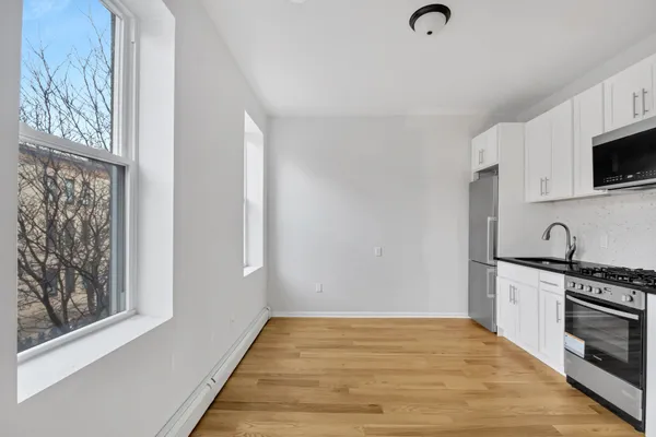 a kitchen with stainless steel appliances granite countertop a stove and a refrigerator
