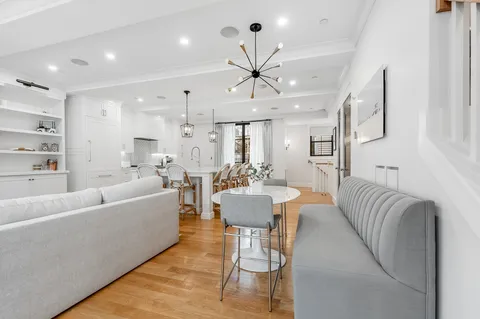 a living room with furniture and a chandelier