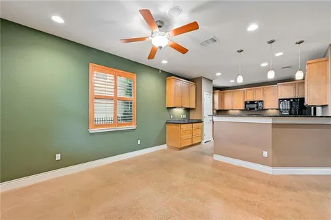 a kitchen with stainless steel appliances granite countertop a sink and cabinets