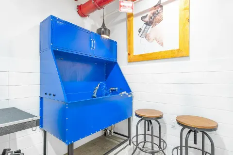 a view of a room with chairs and wooden floor