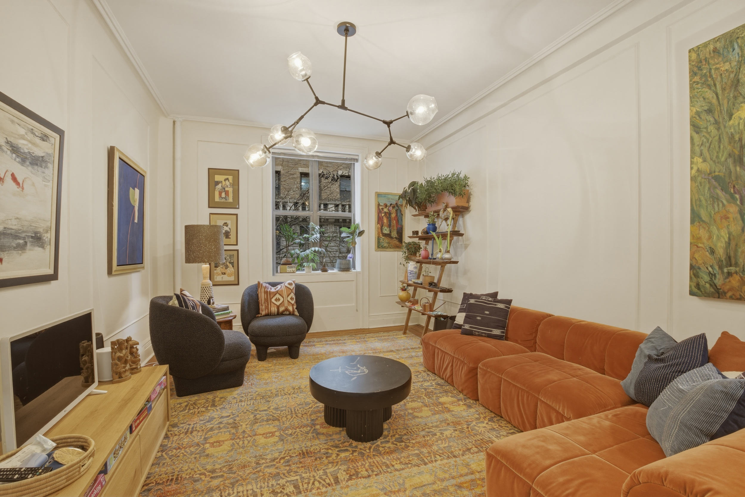 532 West 111th Street, Unit 26 Manhattan, NY 10025 - Photo 3 of 14 a living room with furniture and a chandelier