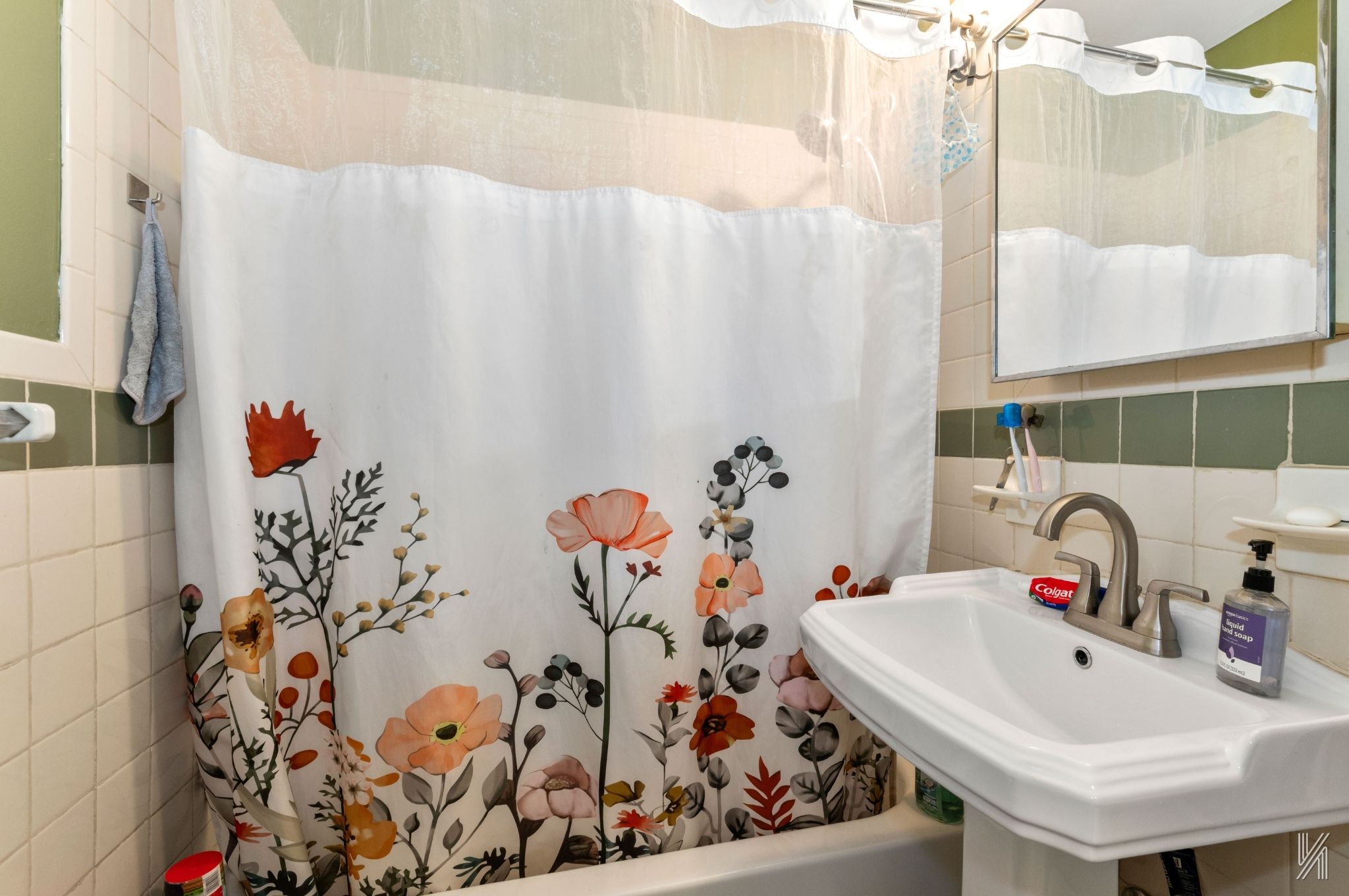 426 54th Street Brooklyn, NY 11220 - Photo 15 of 22 a bathroom with a sink and mirror with bathtub
