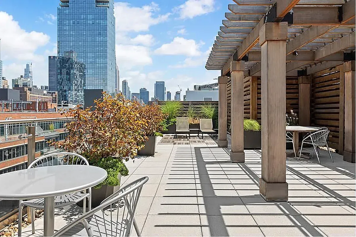 540 West 28th Street, Unit 8A Manhattan, NY 10001 - Photo 7 of 12 a picture of a patio with table and chairs and potted plants