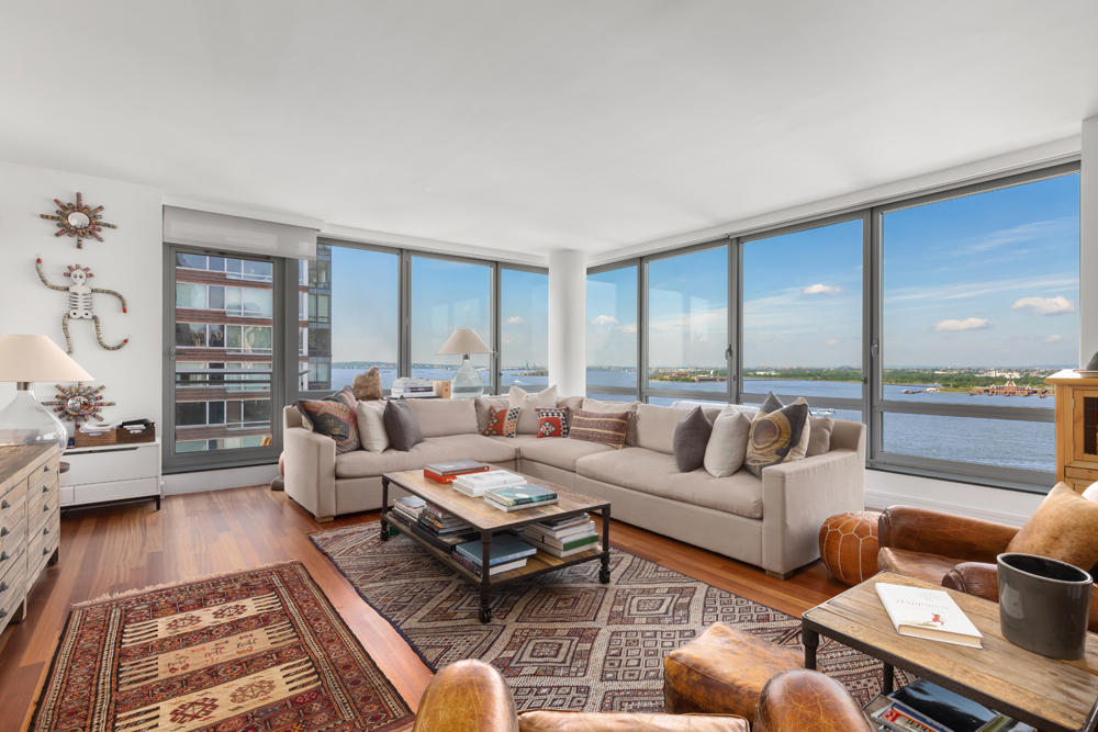 30 West Street, Unit 19F Manhattan, NY 10004 - Photo 1 of 12 a living room with furniture and a large window