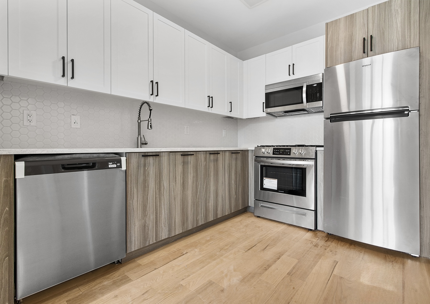 1098 Madison Street, Unit 1B Brooklyn, NY 11221 - Photo 1 of 16 a kitchen with white cabinets and stainless steel appliances