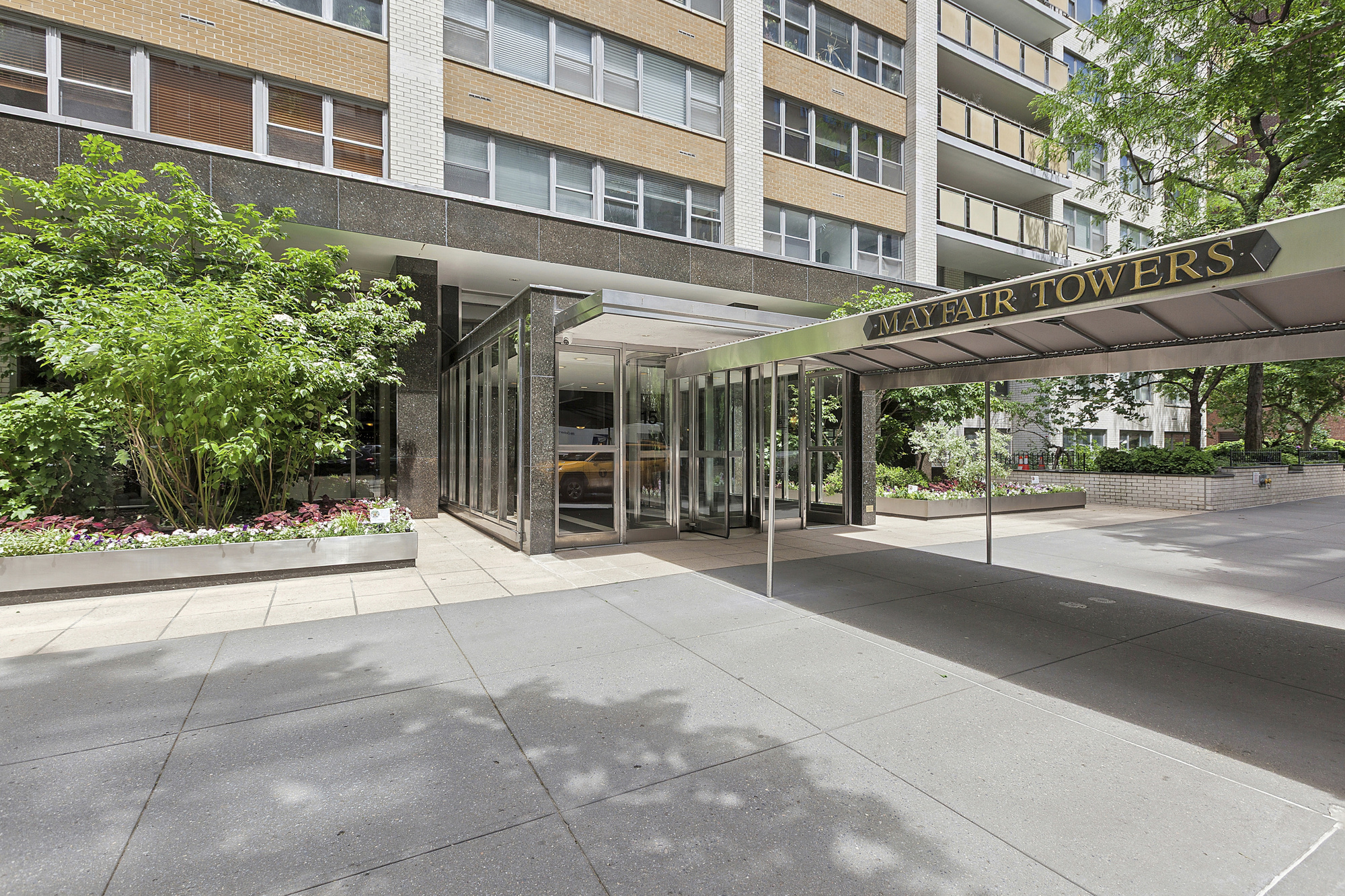 15 West 72nd Street, Unit 25F Manhattan, NY 10023 - Photo 11 of 12 a building exterior with a building and couches in the patio