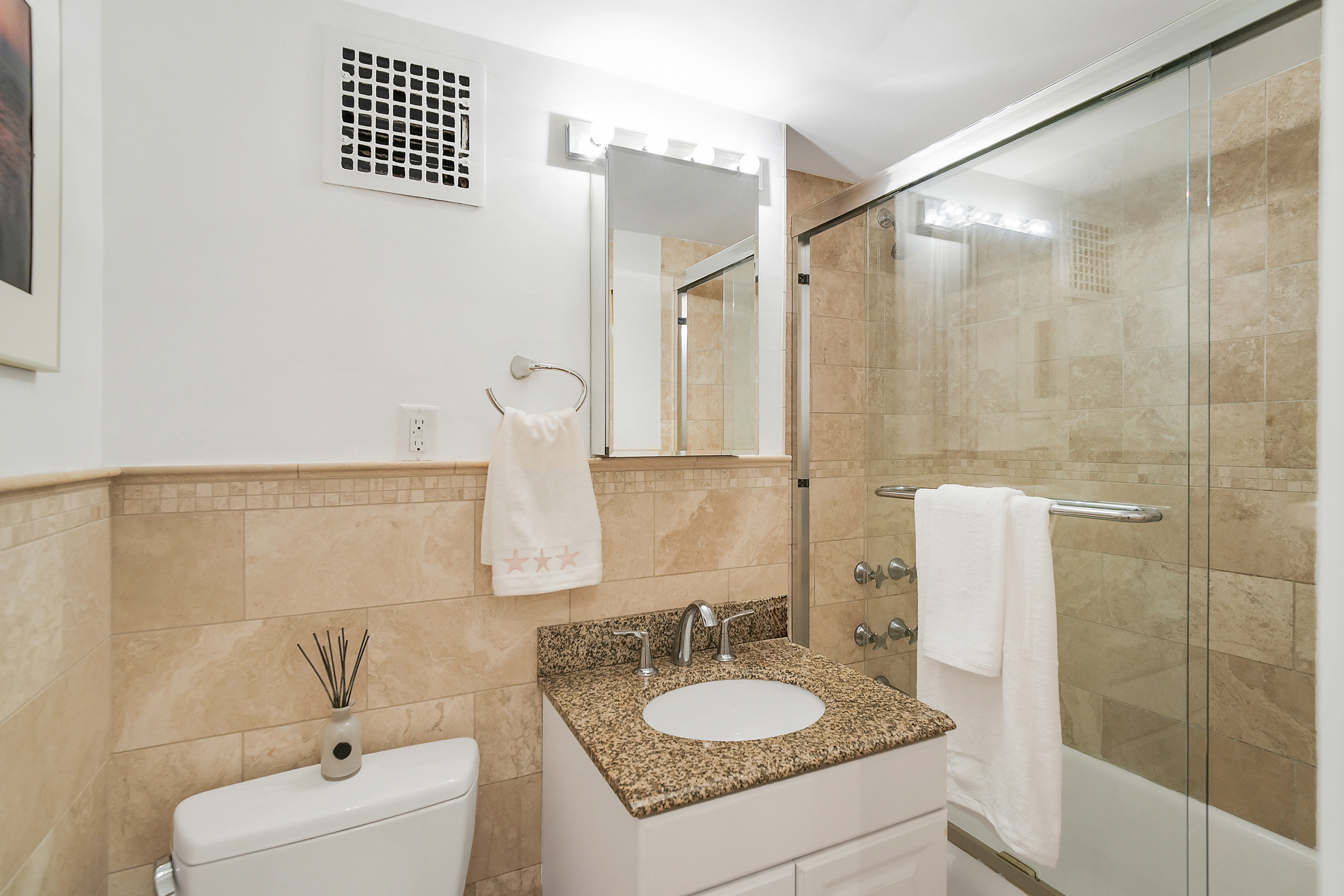 102 West 85th Street, Unit 2B Manhattan, NY 10024 - Photo 8 of 16 a bathroom with a granite countertop sink a mirror and shower