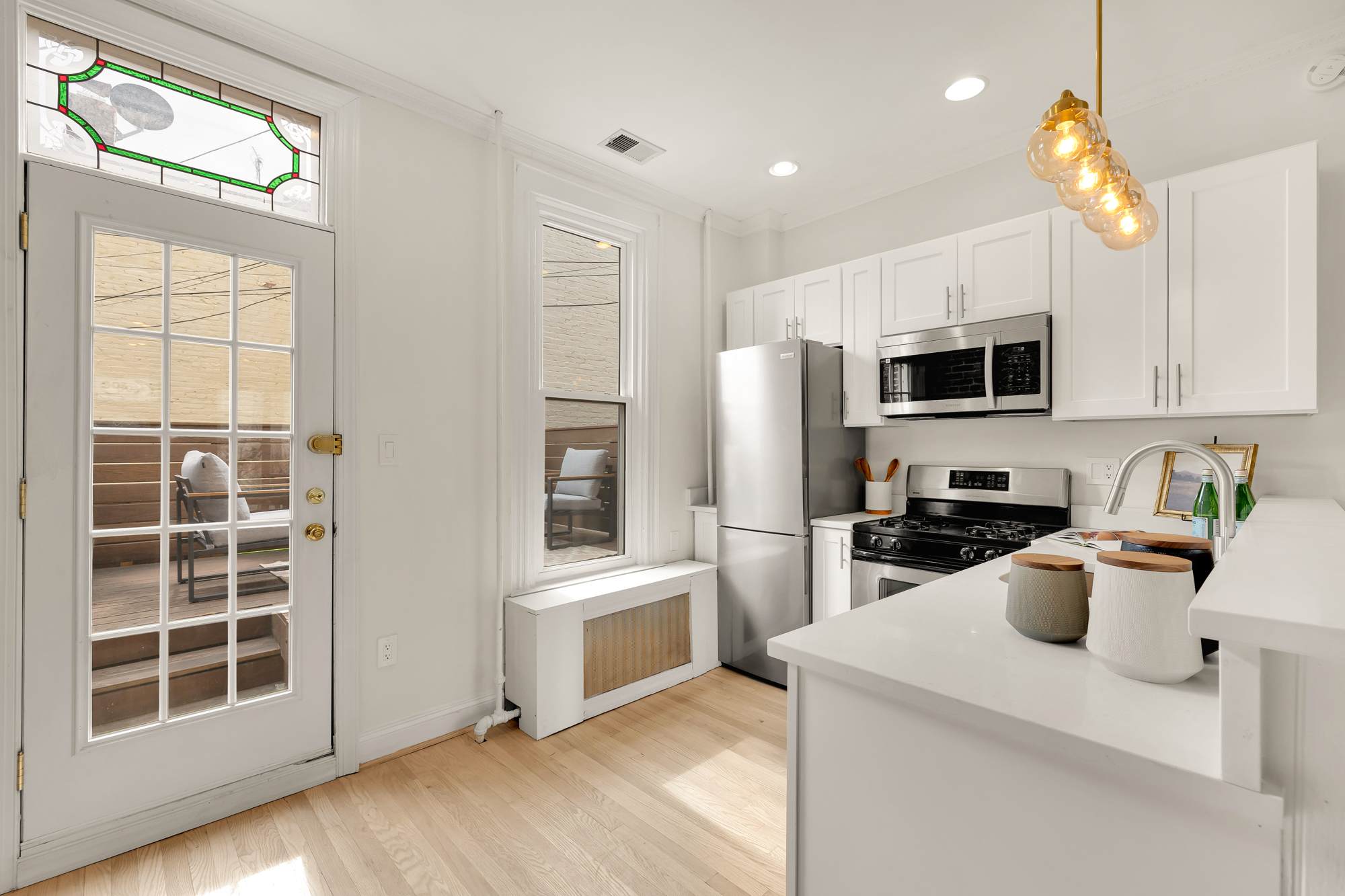 903 F Street Northeast Washington, DC 20002 - Photo 10 of 41 a kitchen with a refrigerator and a stove top oven