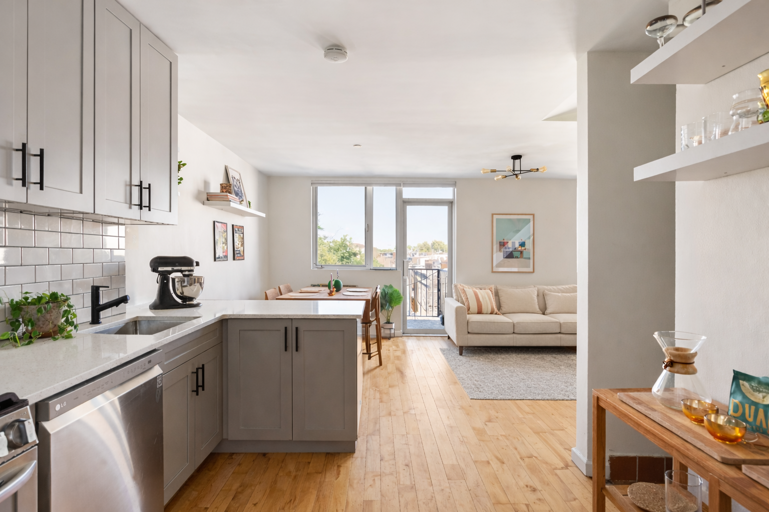 93-95 Wyckoff Avenue, Unit 4B Brooklyn, NY 11237 - Photo 3 of 10 a kitchen with a sink dishwasher stove and white cabinets with wooden floor