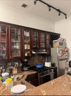 a kitchen with a stove a sink and a refrigerator