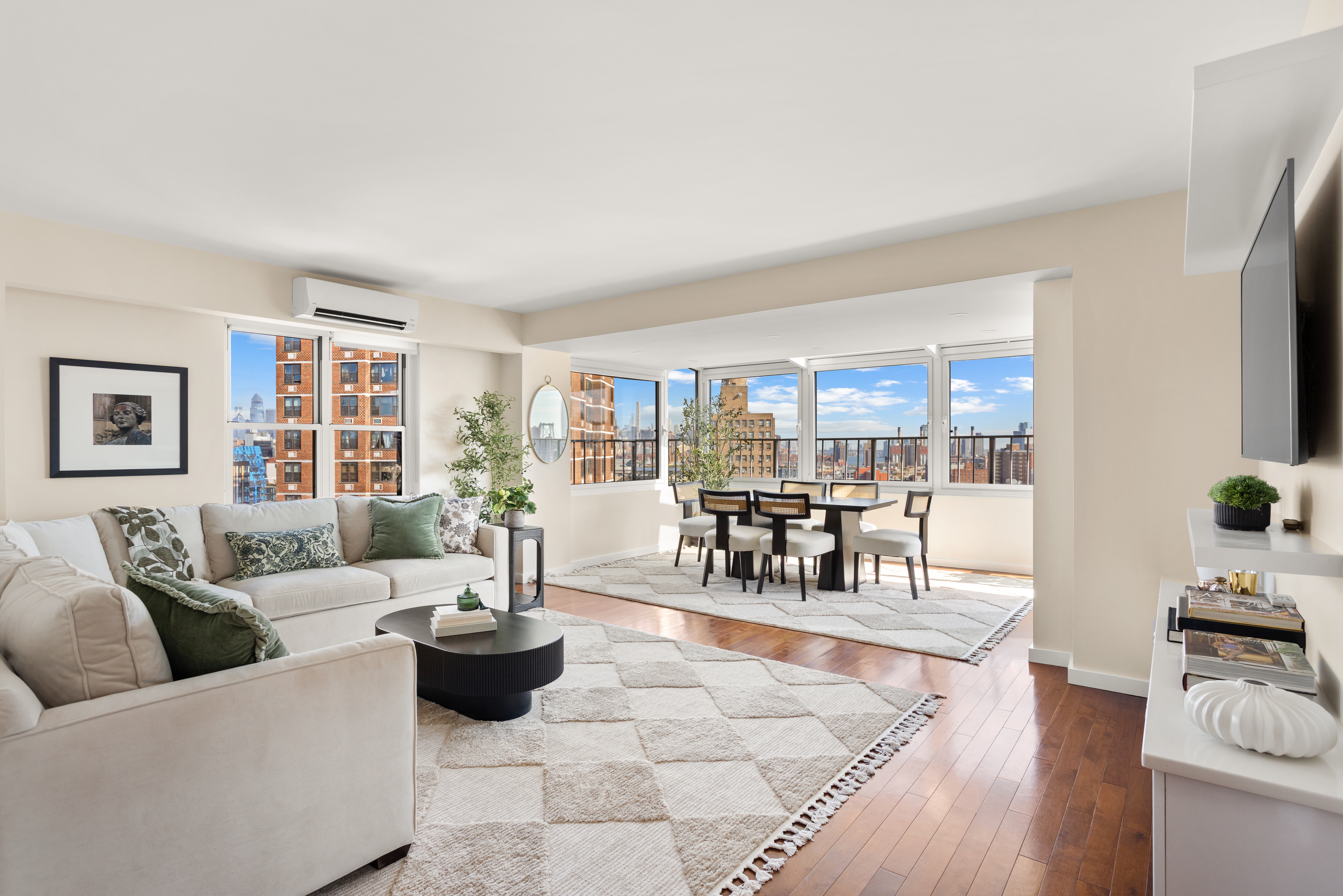 417 Grand Street, Unit D1801 Manhattan, NY 10002 - Photo 2 of 23 a living room with furniture and wooden floor