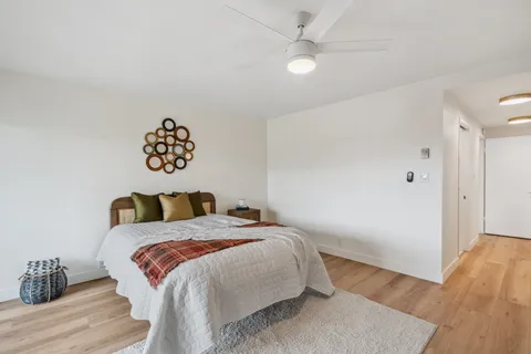 a bedroom with furniture and wooden floor