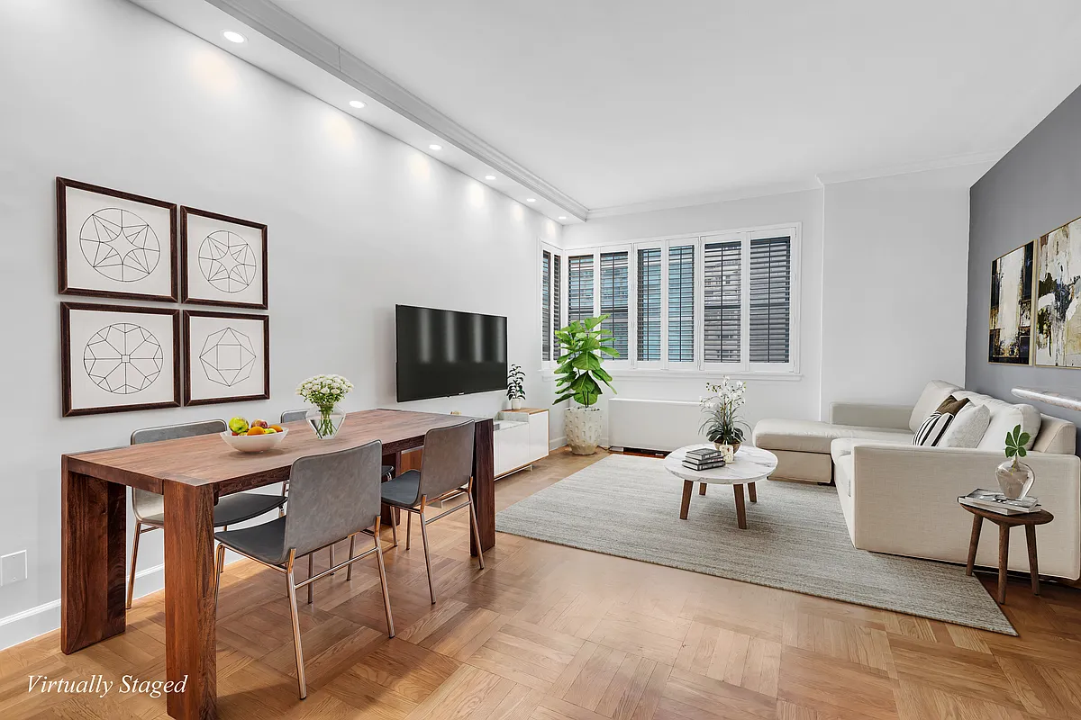a living room with furniture a large window and a flat screen tv